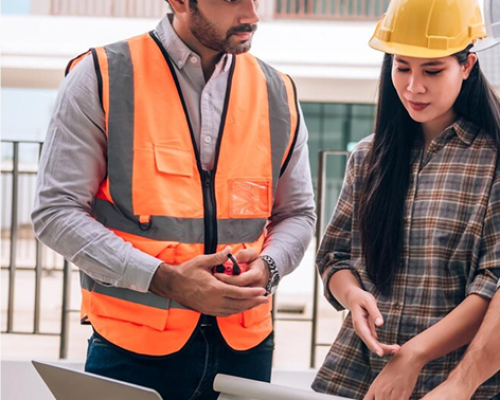 civil-engineer-construction-worker-architects-wearing-hardhats-safety-vests-are-working-together-construction-site-building-home-cooperation-teamwork-concept_640221-172 1